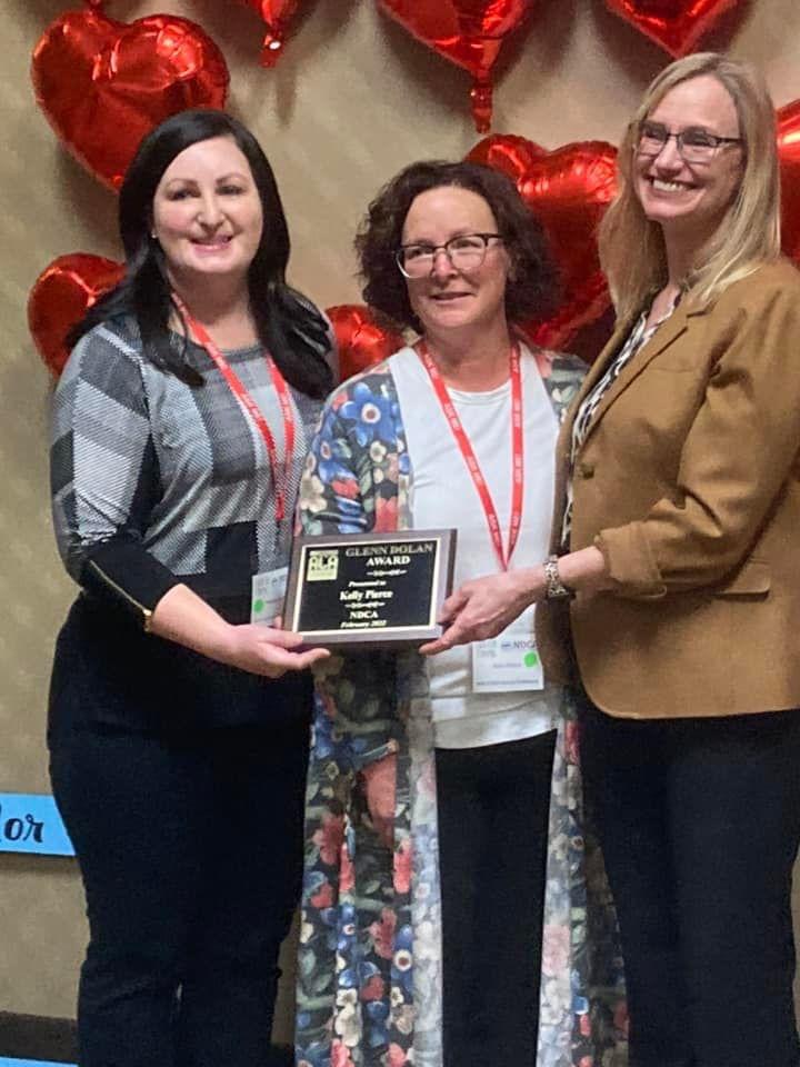 Heather Berg, Kelly Pierce holding Glenn Dolan Award, Laura Glasser